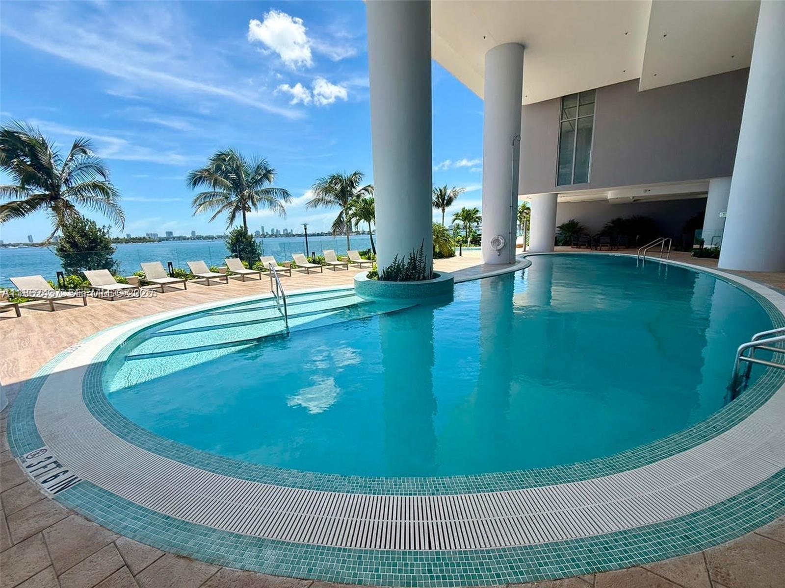 700 Northeast 24th Street, Unit 3304 Miami, FL 33137 - Photo 40 of 64 a view of a swimming pool with an outdoor seating