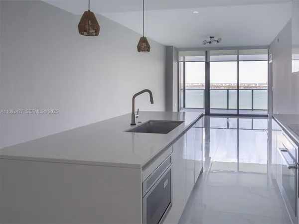 a view of a livingroom with a ceiling fan and a large window