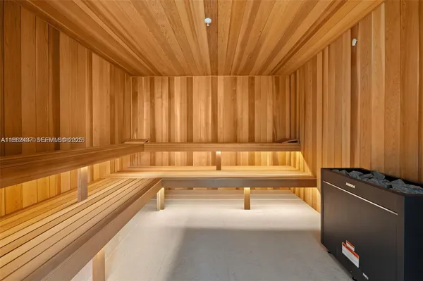 a living room with furniture and a gym machine