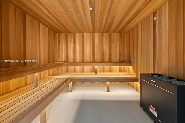 a living room with furniture and a gym machine