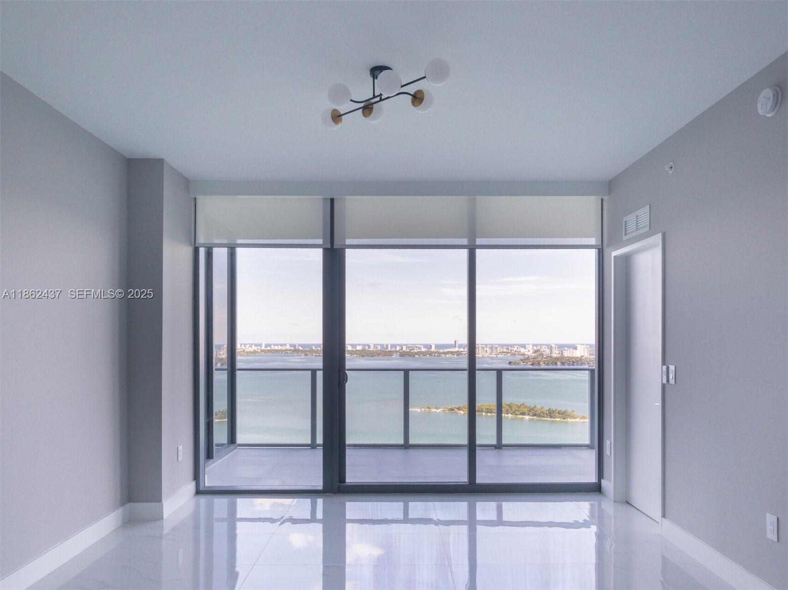 700 Northeast 24th Street, Unit 3304 Miami, FL 33137 - Photo 7 of 64 a view of a livingroom with a ceiling fan and a large window