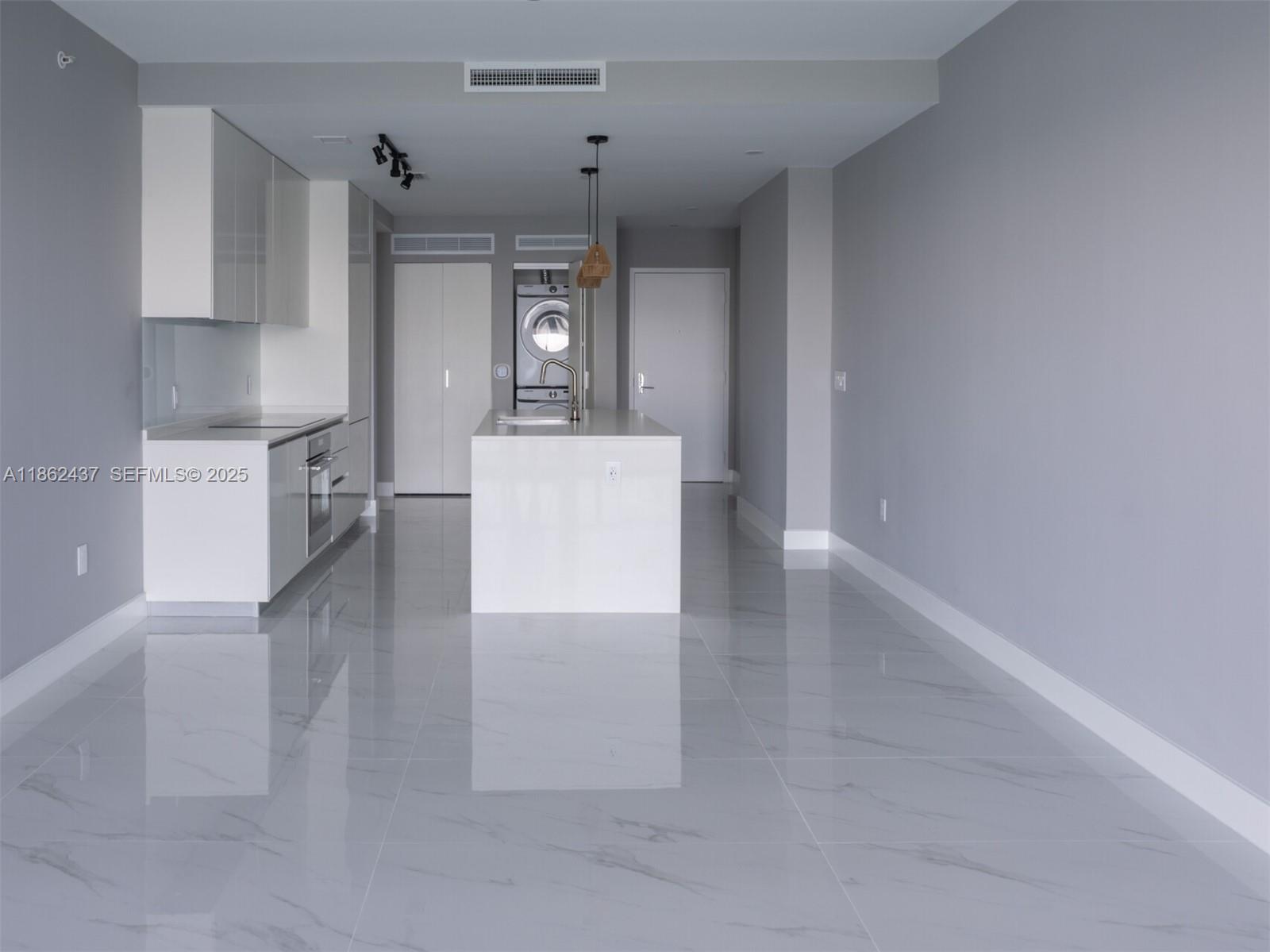 700 Northeast 24th Street, Unit 3304 Miami, FL 33137 - Photo 10 of 64 a view of a kitchen with a sink stove and cabinets