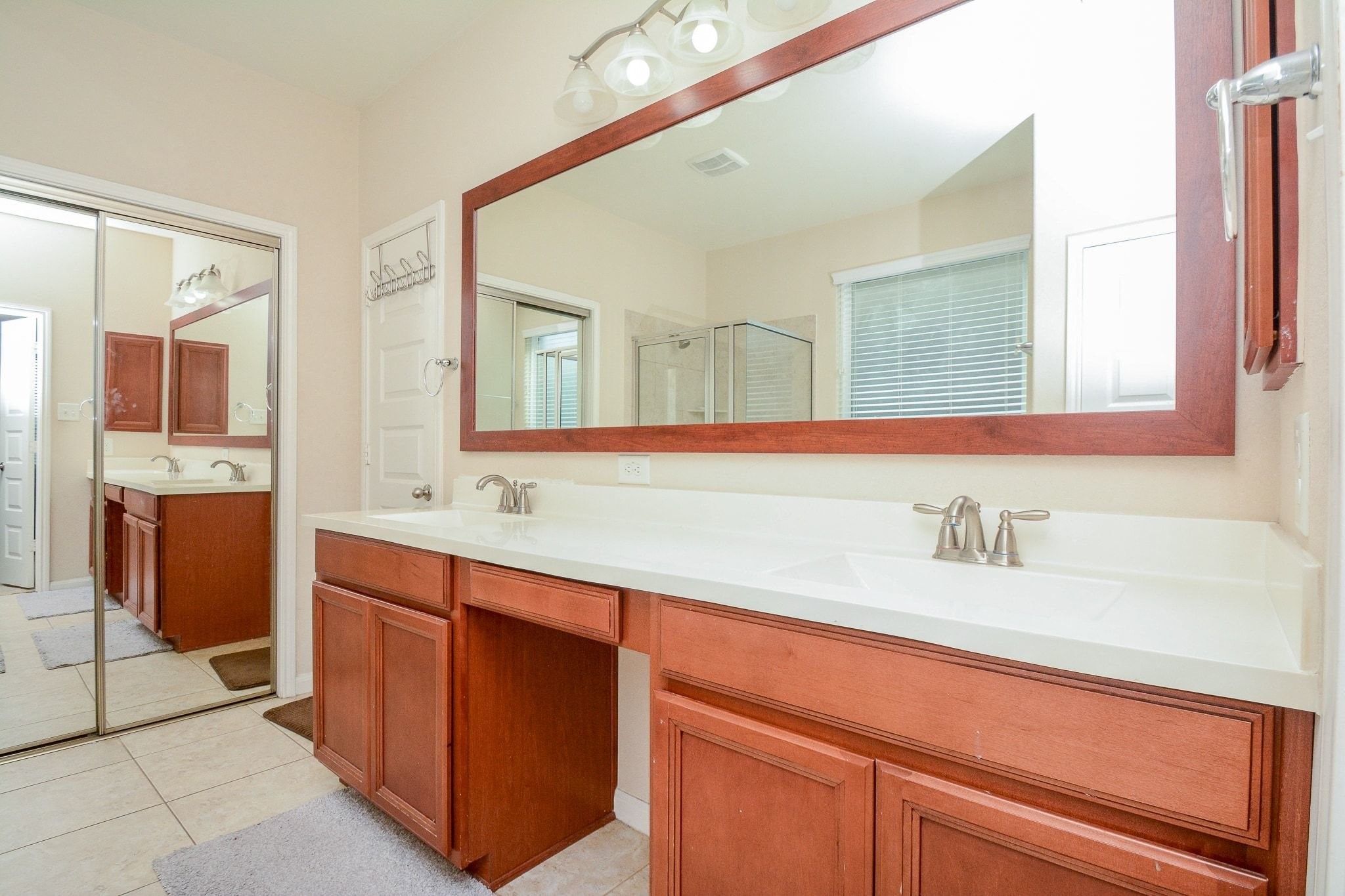 7046 Sliding Rock Circle Spring, TX 77379 - Photo 18 of 41 Efficiently designed primary bathroom sink area with dual sinks, elegant fixtures, and ample storage space.