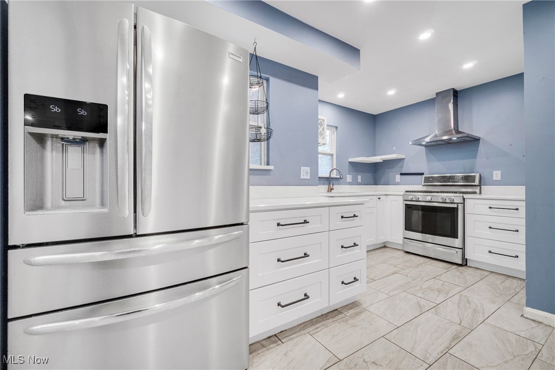 4430 Silsby Road Cleveland, OH 44118 - Photo 22 of 43 Kitchen featuring white cabinetry, sink, wall chimney range hood, and stainless steel appliances