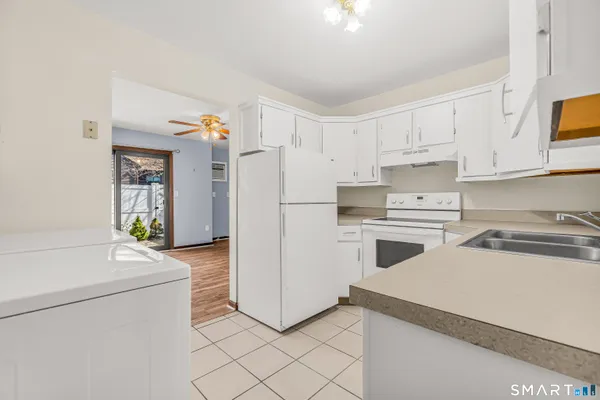 a kitchen with a refrigerator sink stove and cabinets