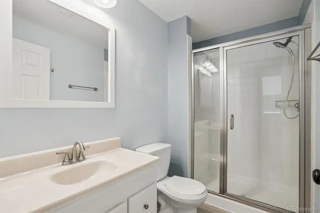 a bathroom with a sink mirror vanity and toilet
