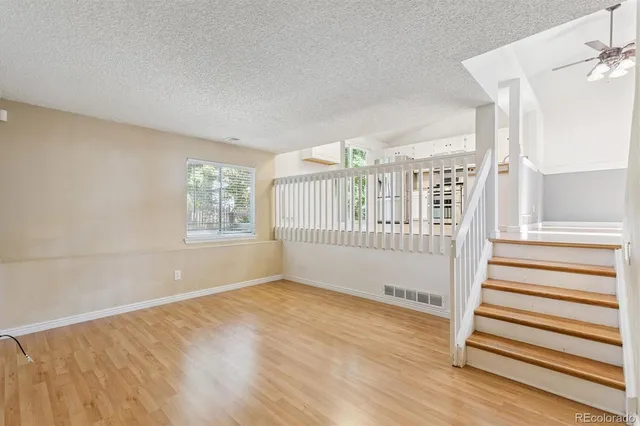 a view of a livingroom with wooden floor and windows