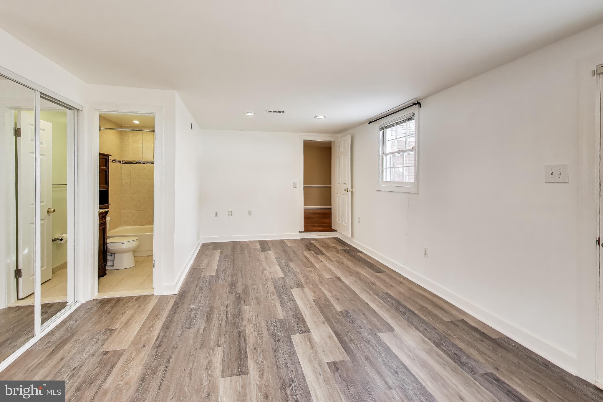 12609 Holdridge Road Silver Spring, MD 20906 - Photo 12 of 30 wooden floor in an empty room with a window