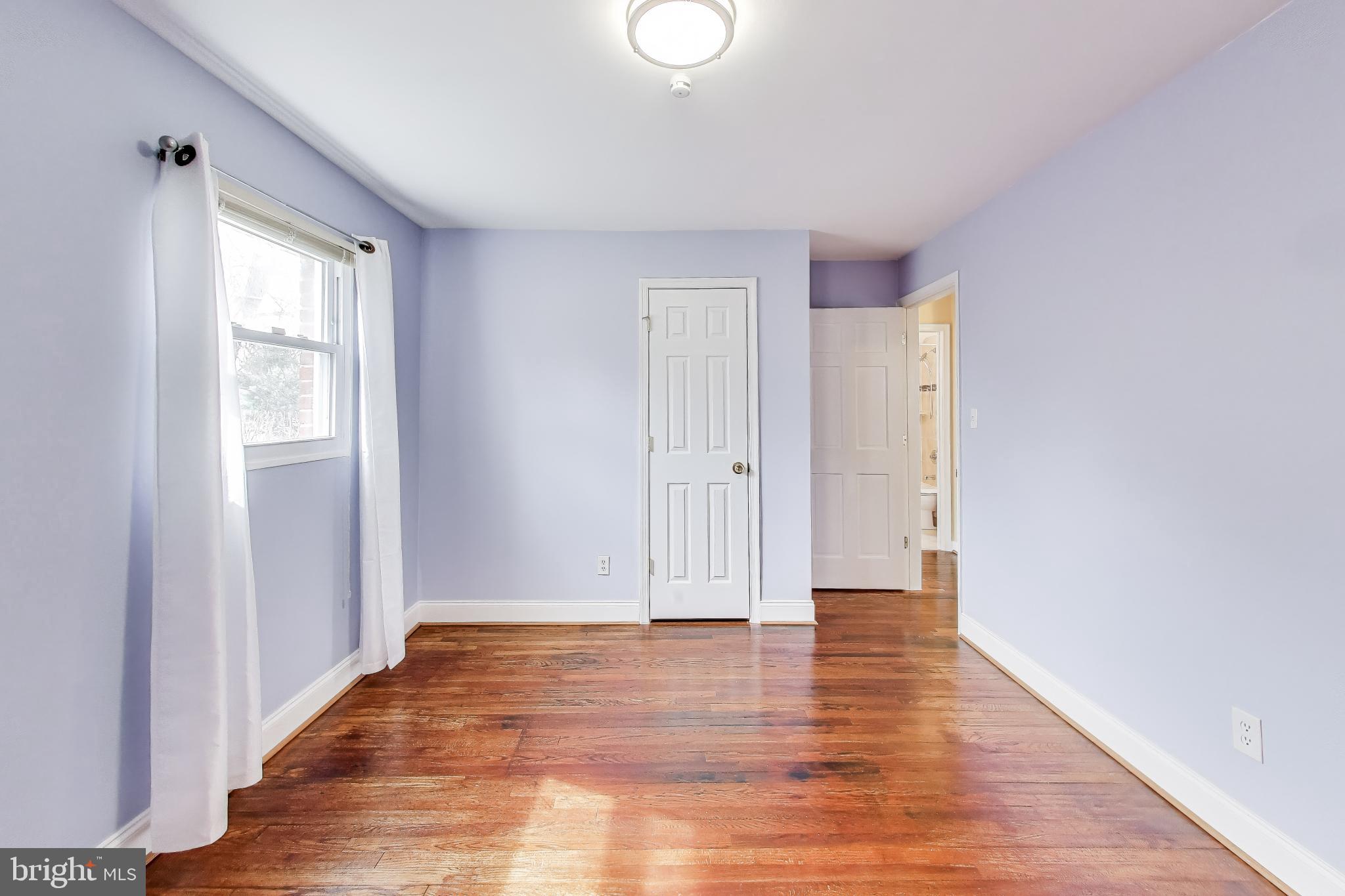 12609 Holdridge Road Silver Spring, MD 20906 - Photo 16 of 30 a view of an empty room with wooden floor and a window