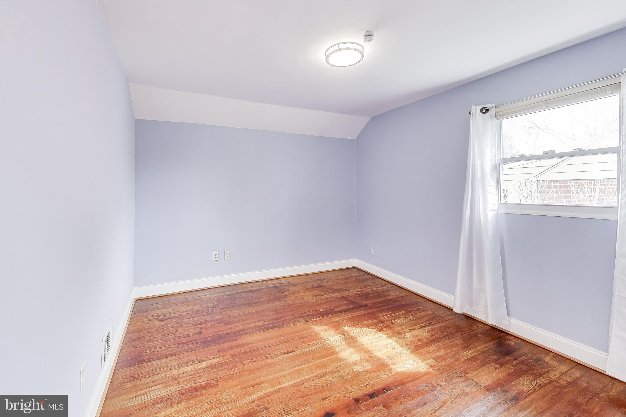 12609 Holdridge Road Silver Spring, MD 20906 - Photo 17 of 30 an empty room with wooden floor and windows