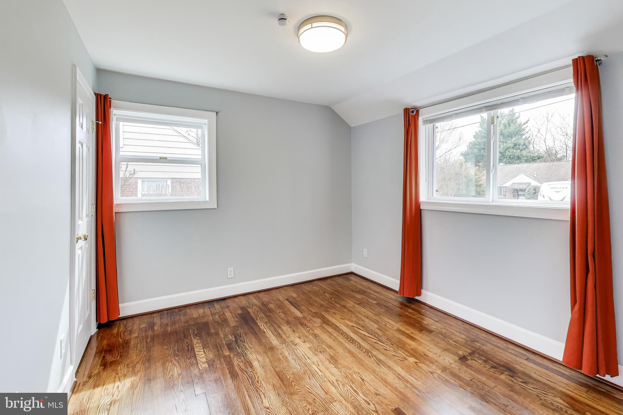 12609 Holdridge Road Silver Spring, MD 20906 - Photo 18 of 30 an empty room with wooden floor and windows
