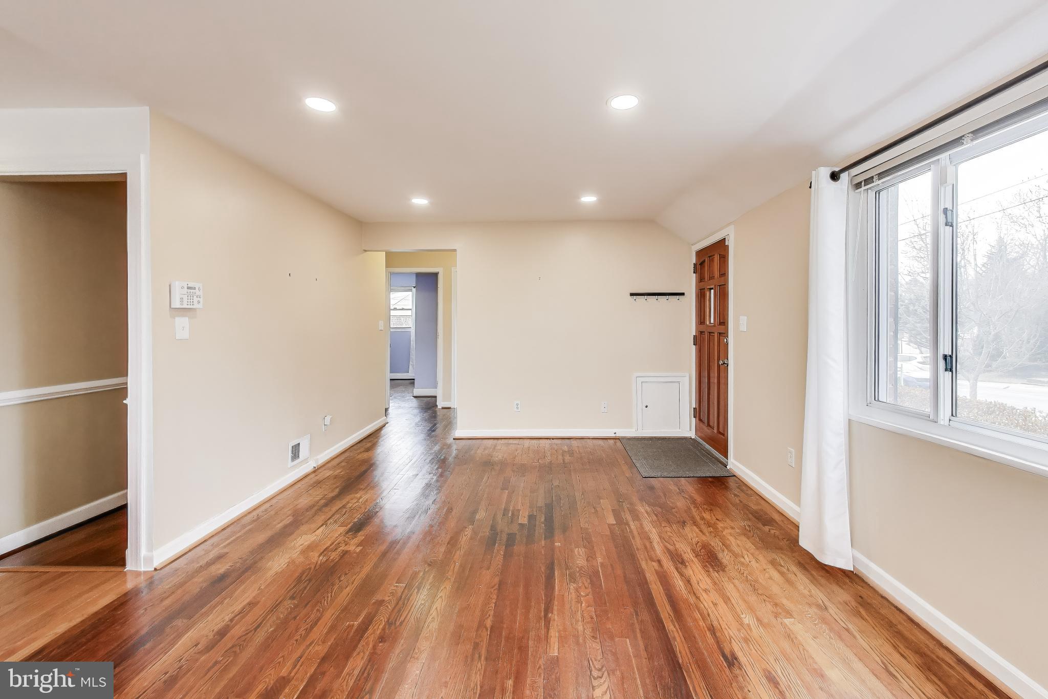 12609 Holdridge Road Silver Spring, MD 20906 - Photo 4 of 30 a view of hallway with a large window and wooden floor