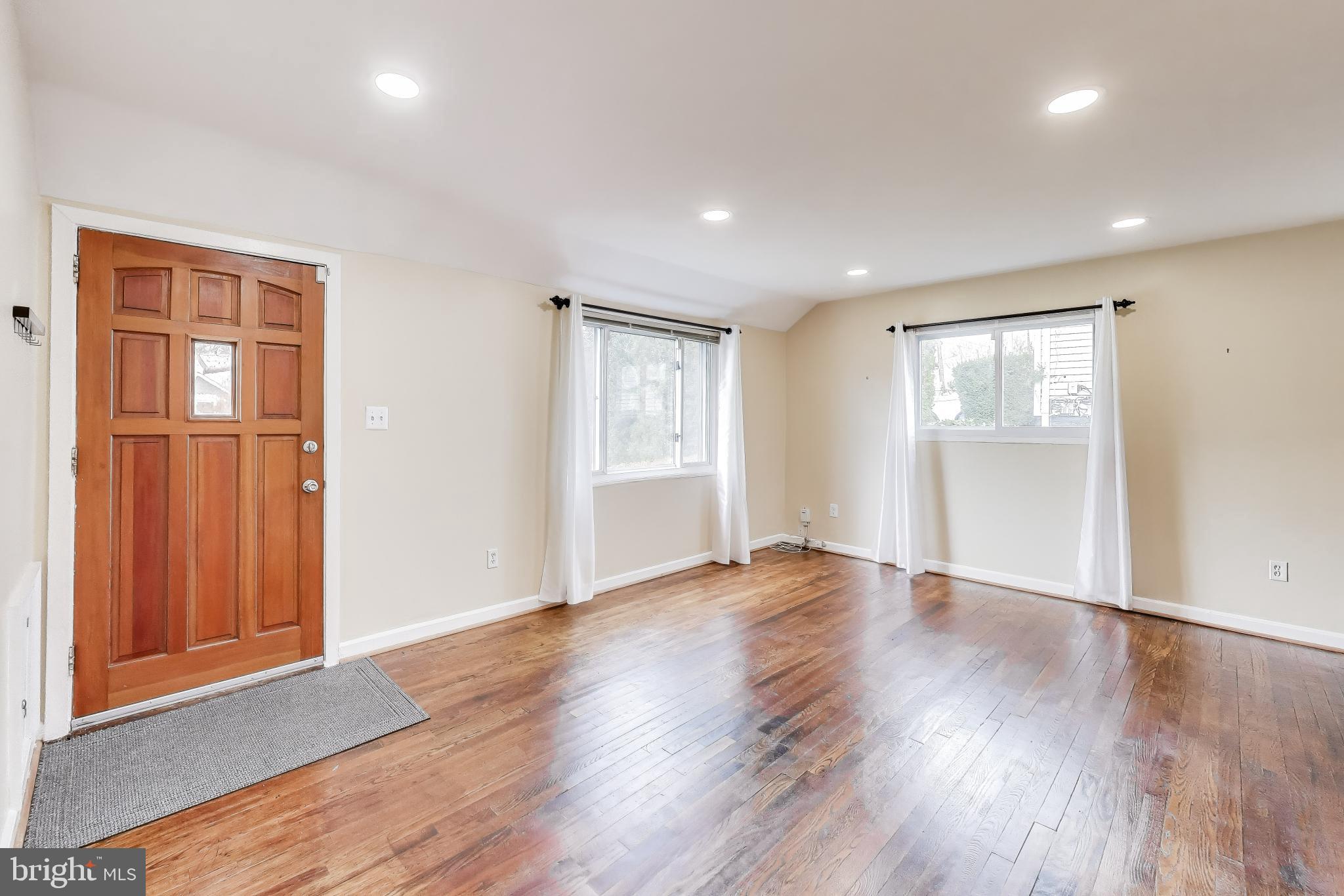 12609 Holdridge Road Silver Spring, MD 20906 - Photo 6 of 30 an empty room with wooden floor and windows