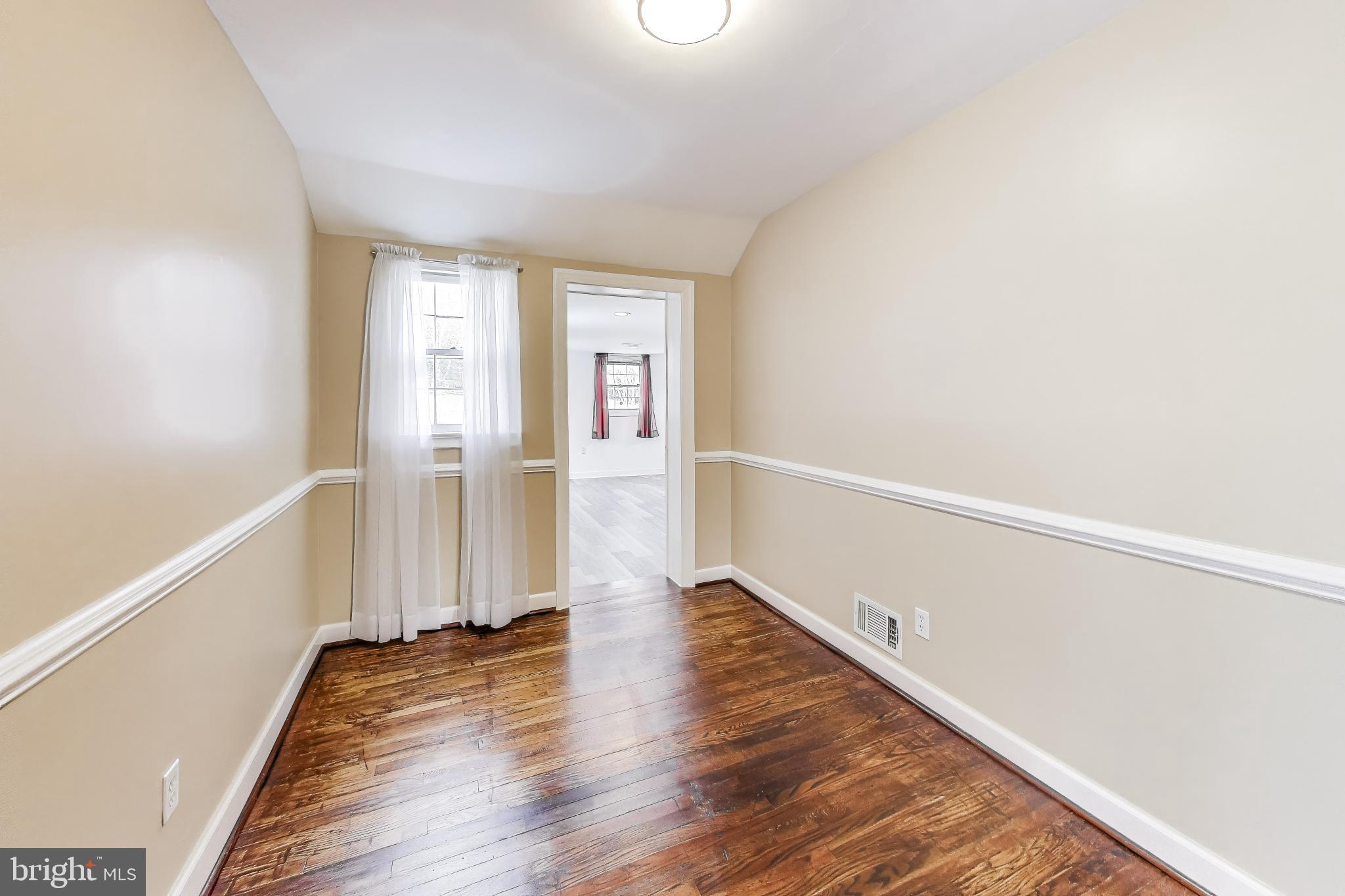 12609 Holdridge Road Silver Spring, MD 20906 - Photo 10 of 30 a view of a room with wooden floor and white walls