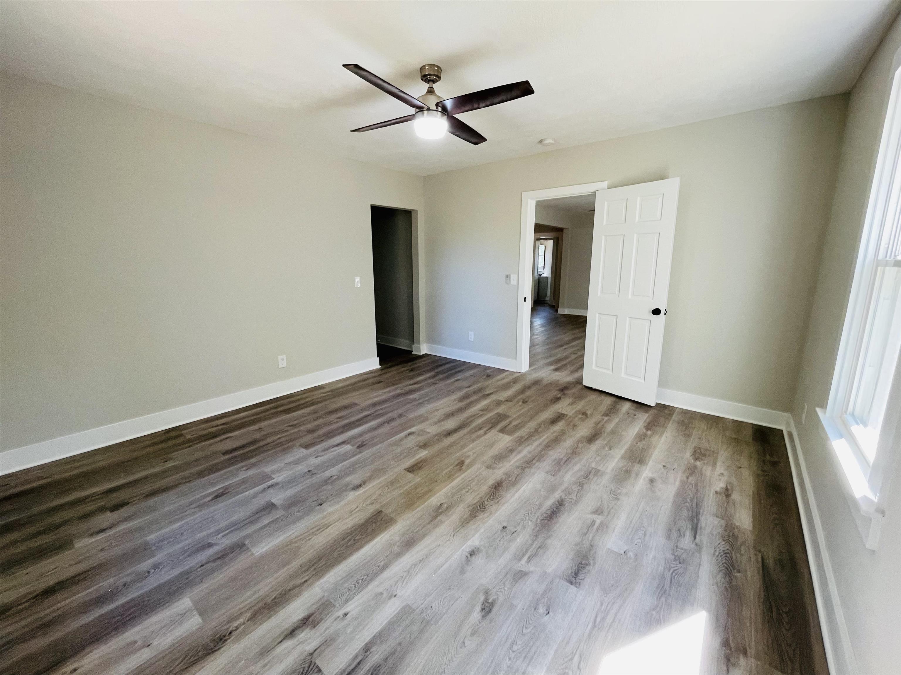 6490 Highway 226 Savannah, TN 38372 - Photo 11 of 38 a view of a livingroom with wooden floor and a ceiling fan