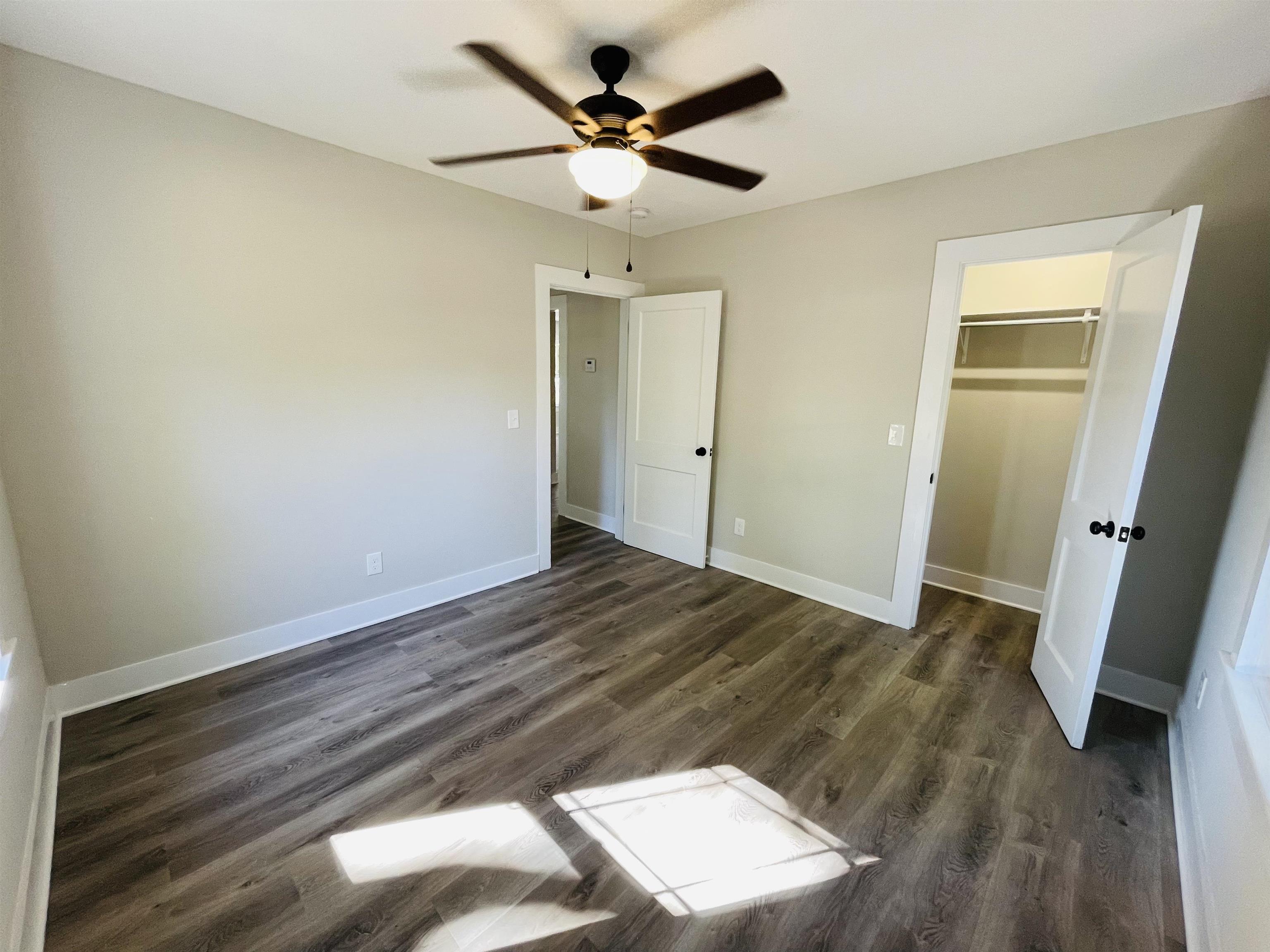 6490 Highway 226 Savannah, TN 38372 - Photo 16 of 38 an empty room with wooden floor and ceiling fan