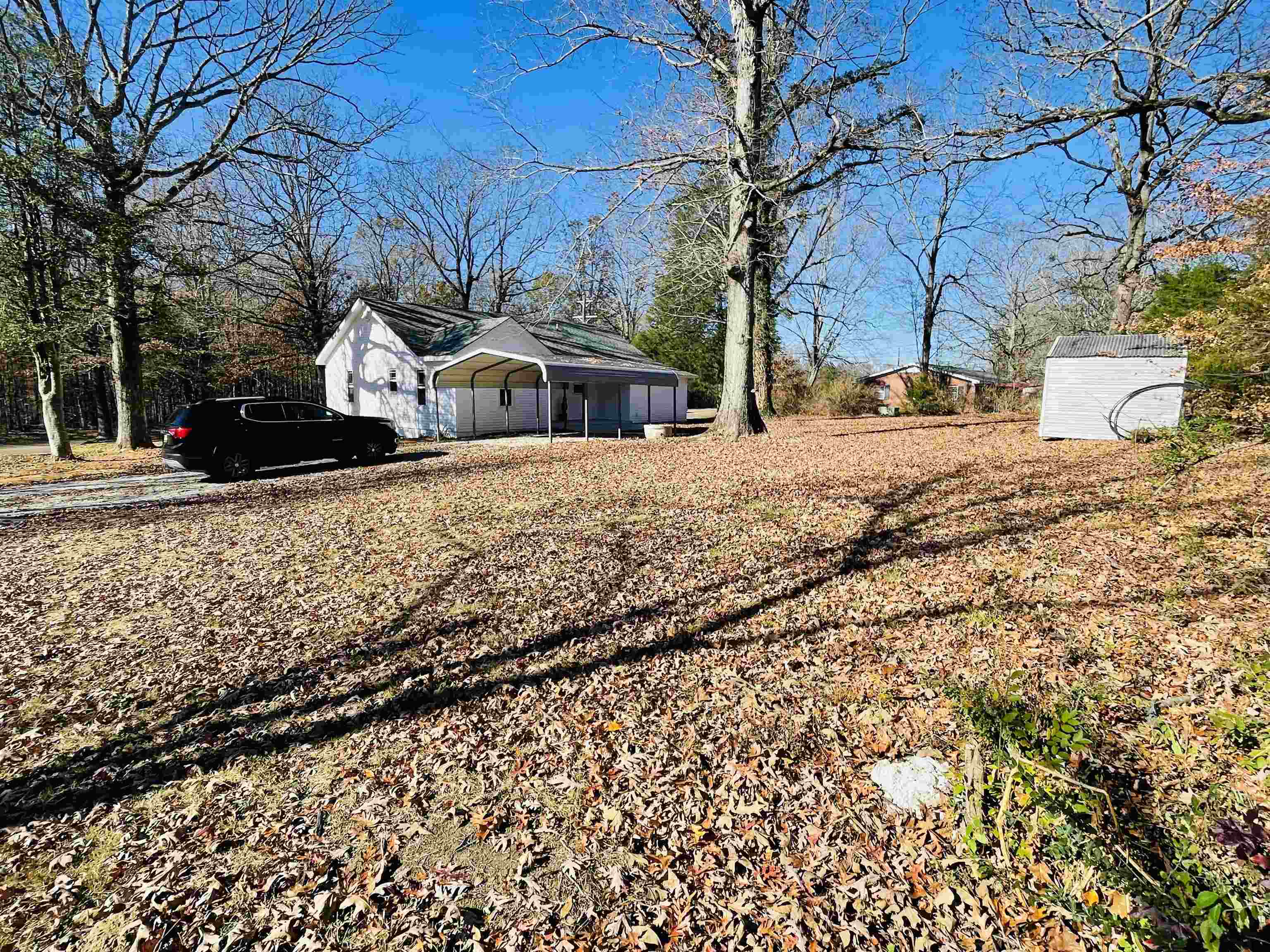 6490 Highway 226 Savannah, TN 38372 - Photo 2 of 38 a front view of a house with a yard covered with snow and trees