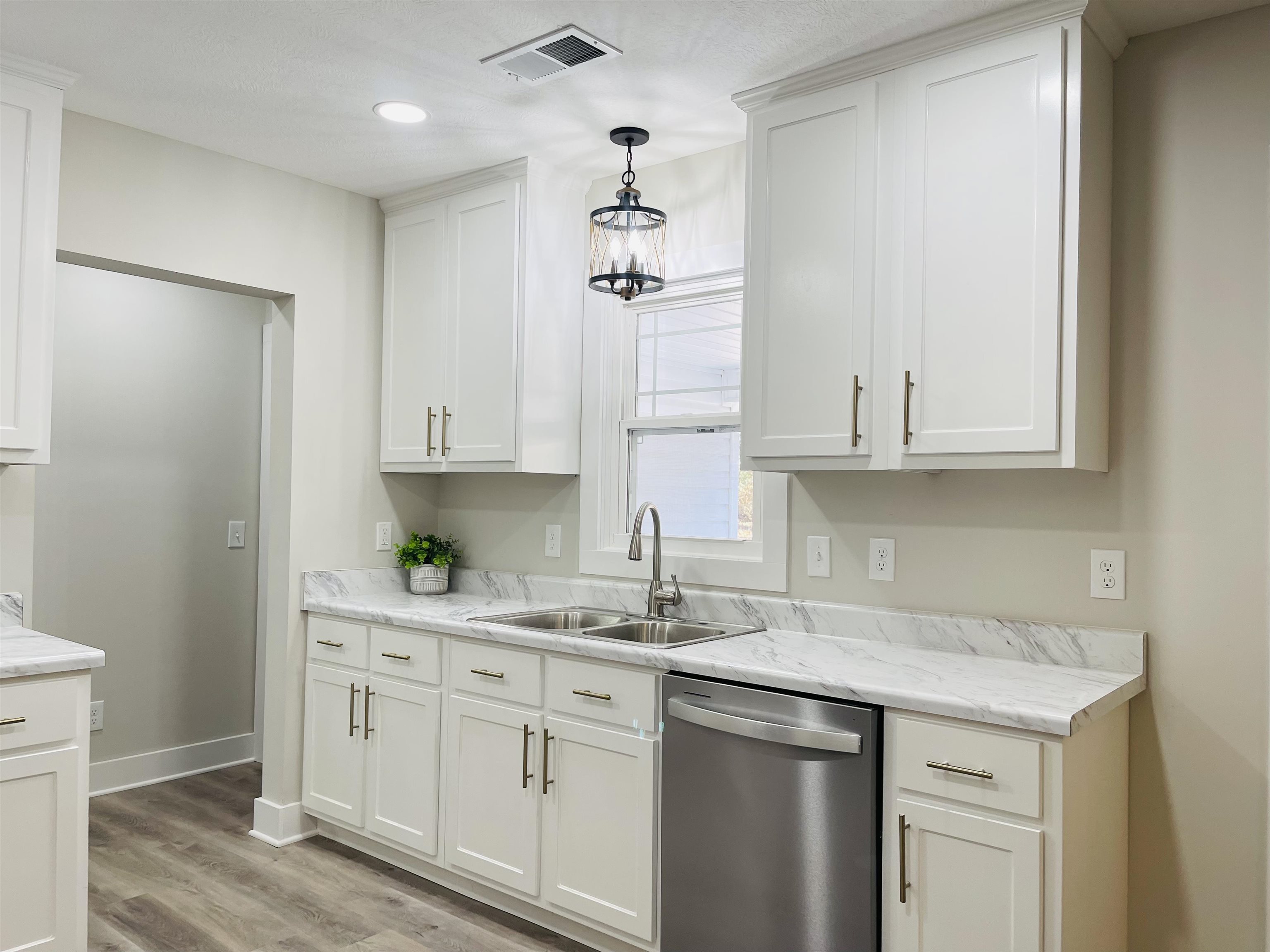 6490 Highway 226 Savannah, TN 38372 - Photo 8 of 38 a kitchen with white cabinets and a sink