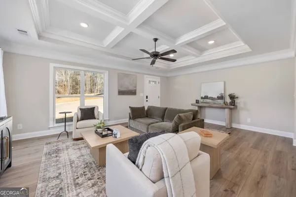 a kitchen with stainless steel appliances granite countertop a sink a chandelier and wooden floor
