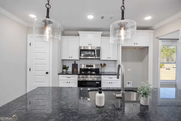 a kitchen with kitchen island a counter top space cabinets and wooden floor