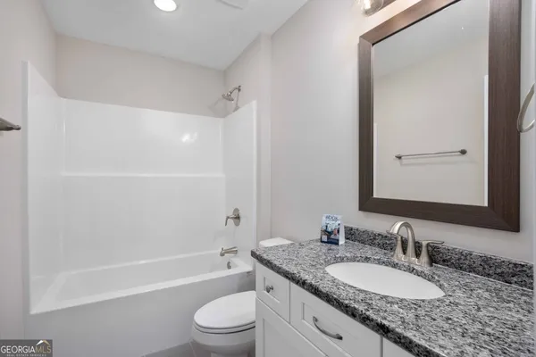 a view of wooden floor and a chandelier fan in a room