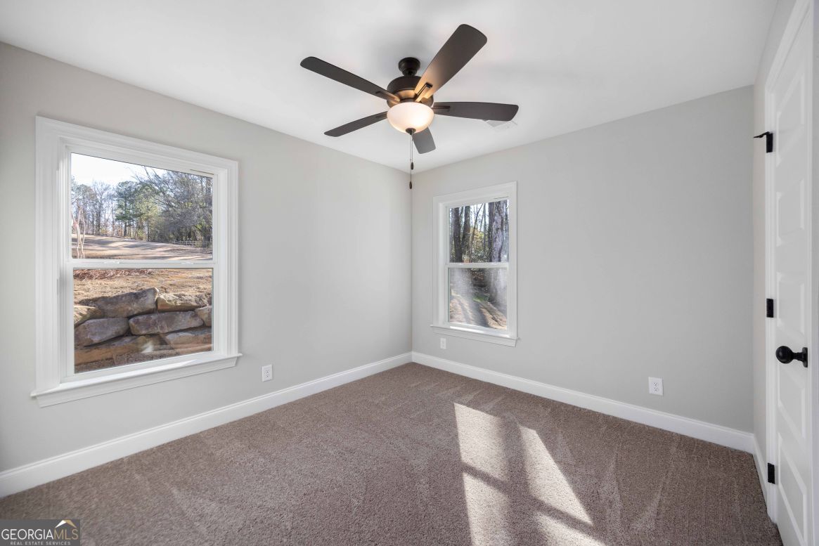 23 Rivers Edge Lane Franklin, GA 30217 - Photo 20 of 32 a view of wooden floor and a chandelier fan in a room
