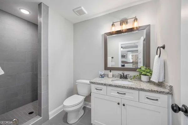 a spacious bedroom with a bed and a chandelier