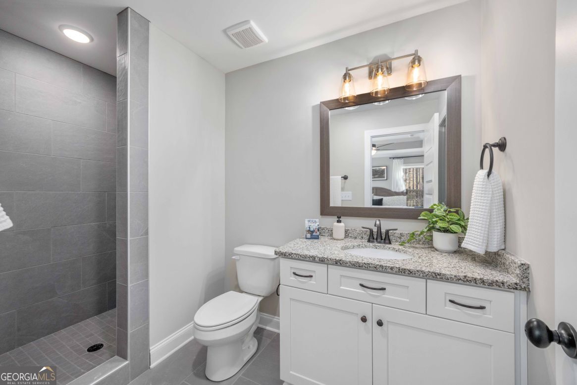 23 Rivers Edge Lane Franklin, GA 30217 - Photo 23 of 32 a bathroom with a granite countertop sink mirror and toilet