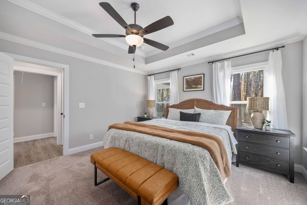 23 Rivers Edge Lane Franklin, GA 30217 - Photo 24 of 32 a spacious bedroom with a bed and a chandelier