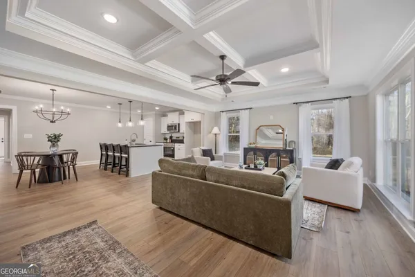 a living room with furniture and a chandelier