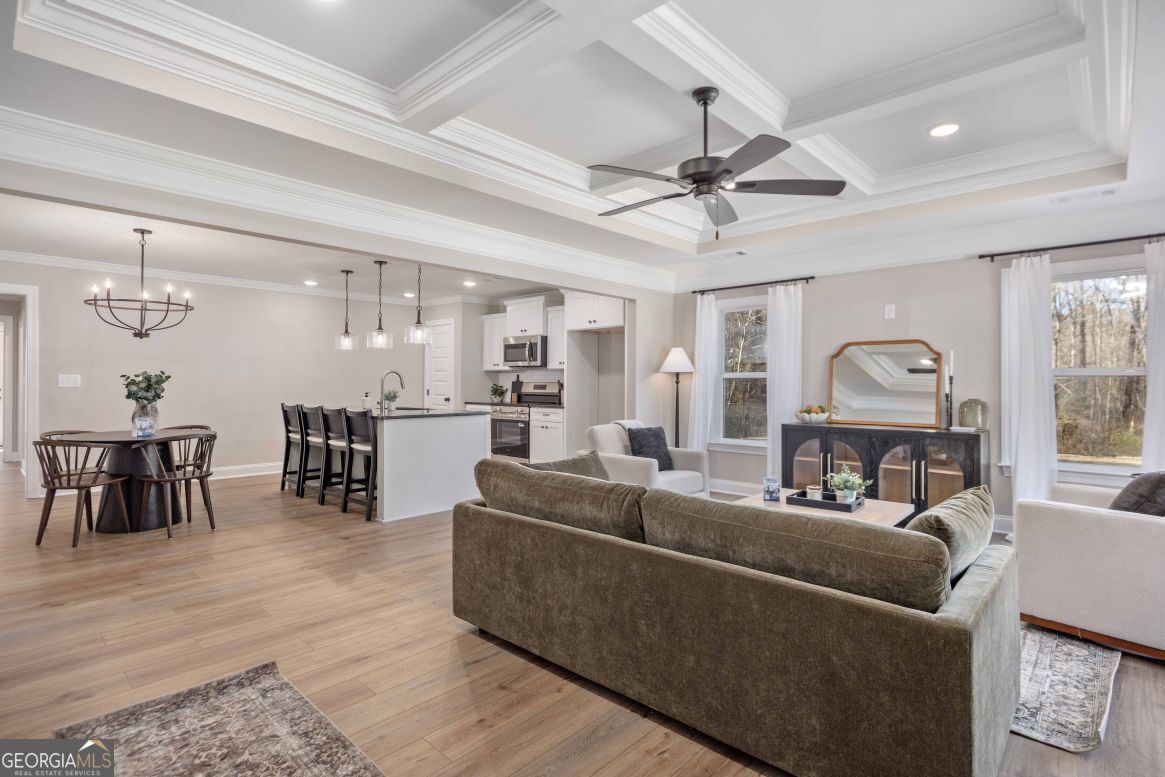 23 Rivers Edge Lane Franklin, GA 30217 - Photo 8 of 32 a living room with furniture and a chandelier