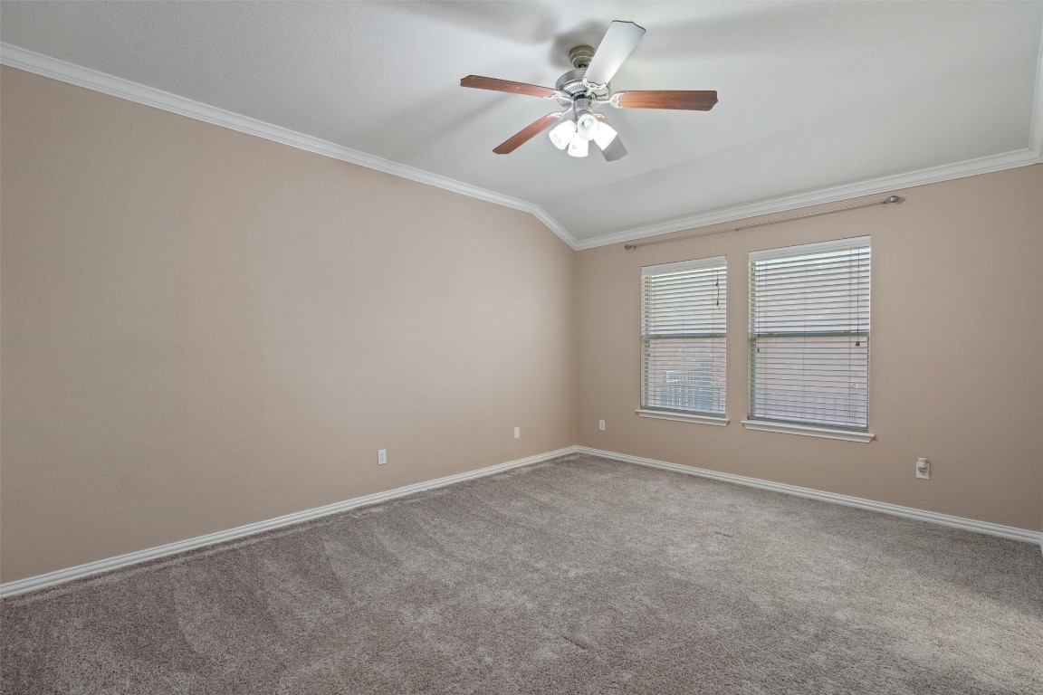1609 Hidden Springs Path Round Rock, TX 78665 - Photo 12 of 37 an empty room with chandelier fan and windows
