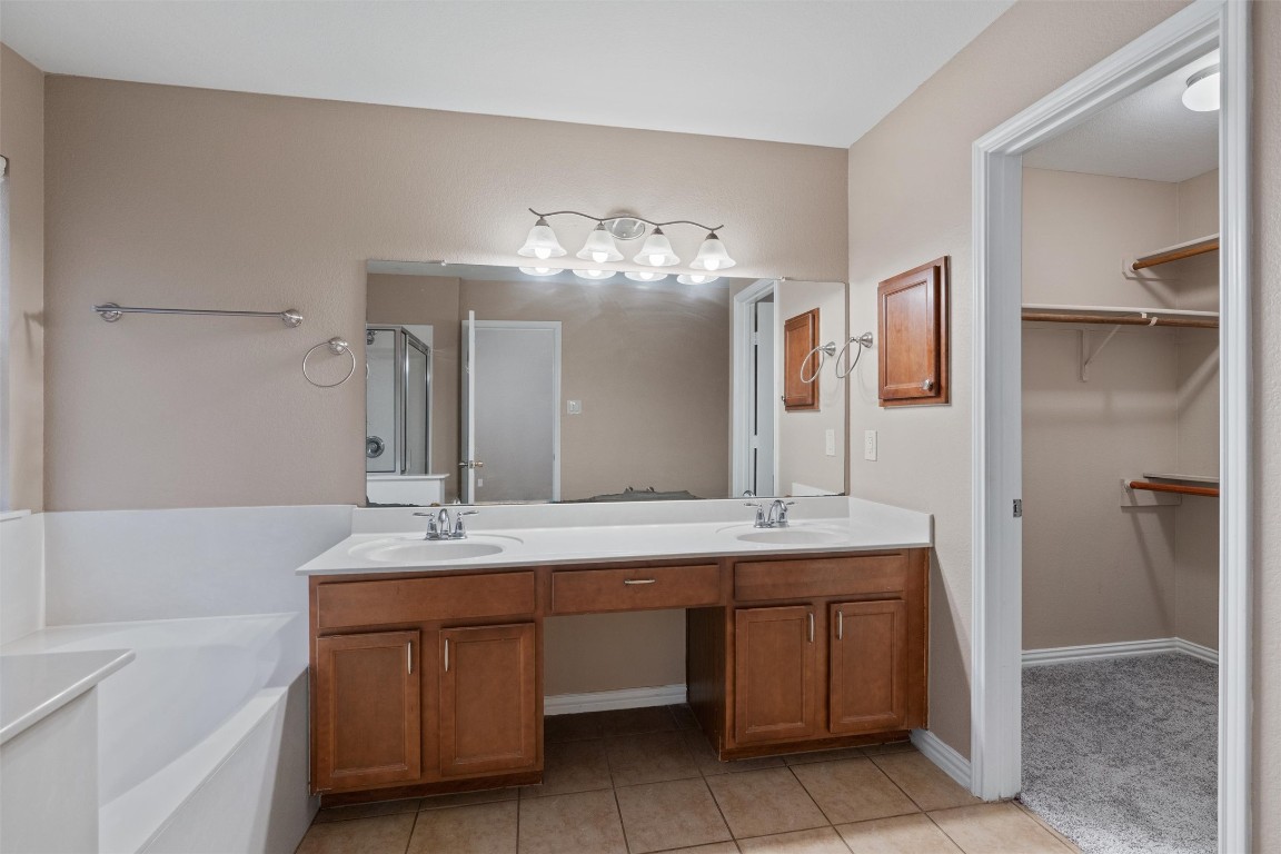 1609 Hidden Springs Path Round Rock, TX 78665 - Photo 14 of 37 a bathroom with a sink and a mirror