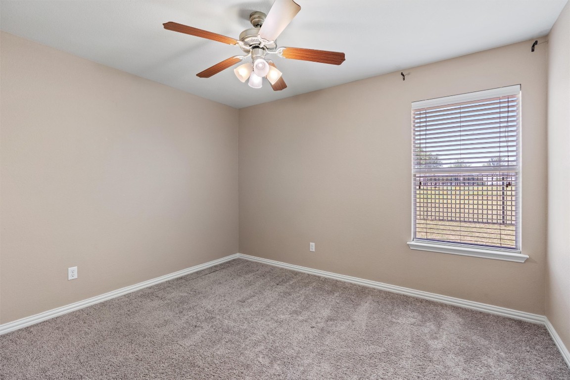 1609 Hidden Springs Path Round Rock, TX 78665 - Photo 21 of 37 an empty room with a window and a fan