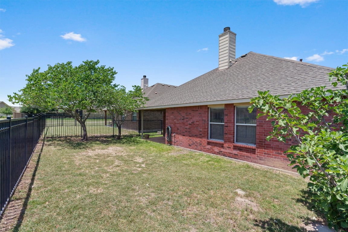 1609 Hidden Springs Path Round Rock, TX 78665 - Photo 26 of 37 a front view of a house with a yard and garage