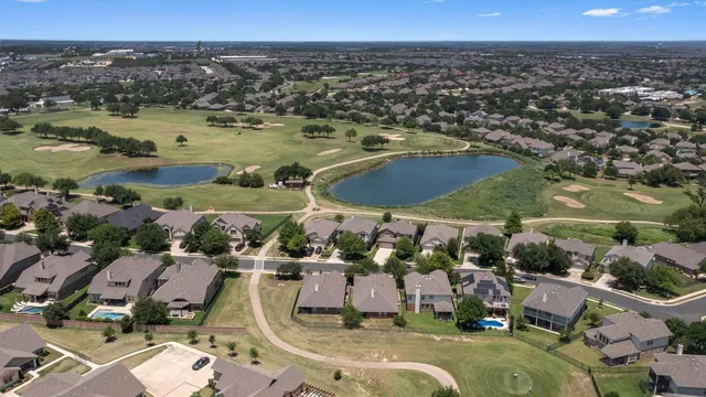 an aerial view of a residential houses with outdoor space