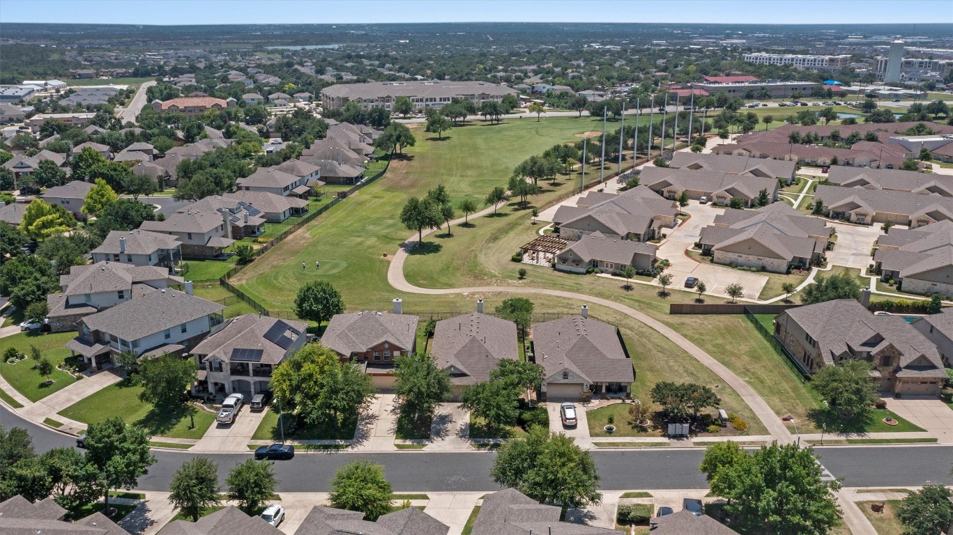 1609 Hidden Springs Path Round Rock, TX 78665 - Photo 3 of 37 an aerial view of a city with lots of residential buildings and mountain view in back