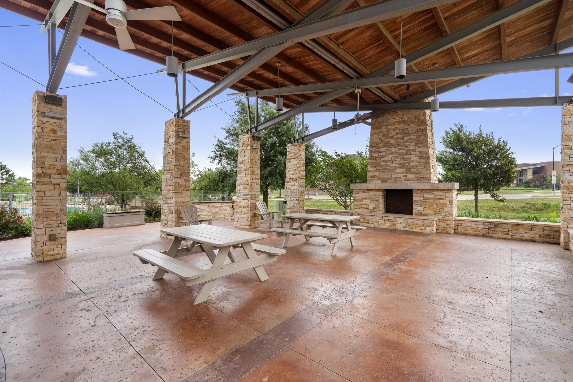1609 Hidden Springs Path Round Rock, TX 78665 - Photo 31 of 37 a view of a patio with a table and chairs under an umbrella