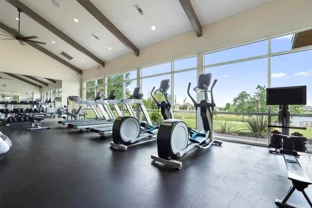 a room with gym equipment and a view of living room