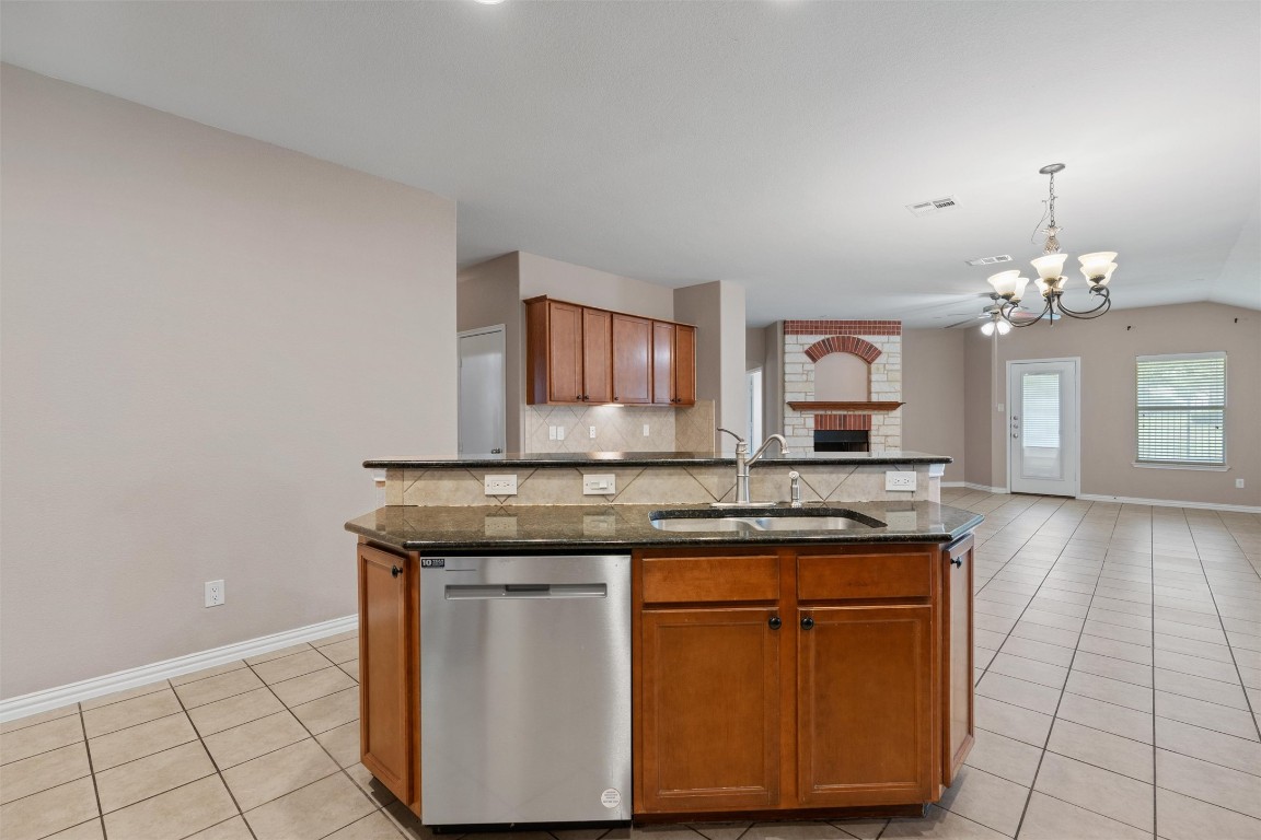 1609 Hidden Springs Path Round Rock, TX 78665 - Photo 7 of 37 a view of a kitchen with granite countertop cabinets a sink and a stove