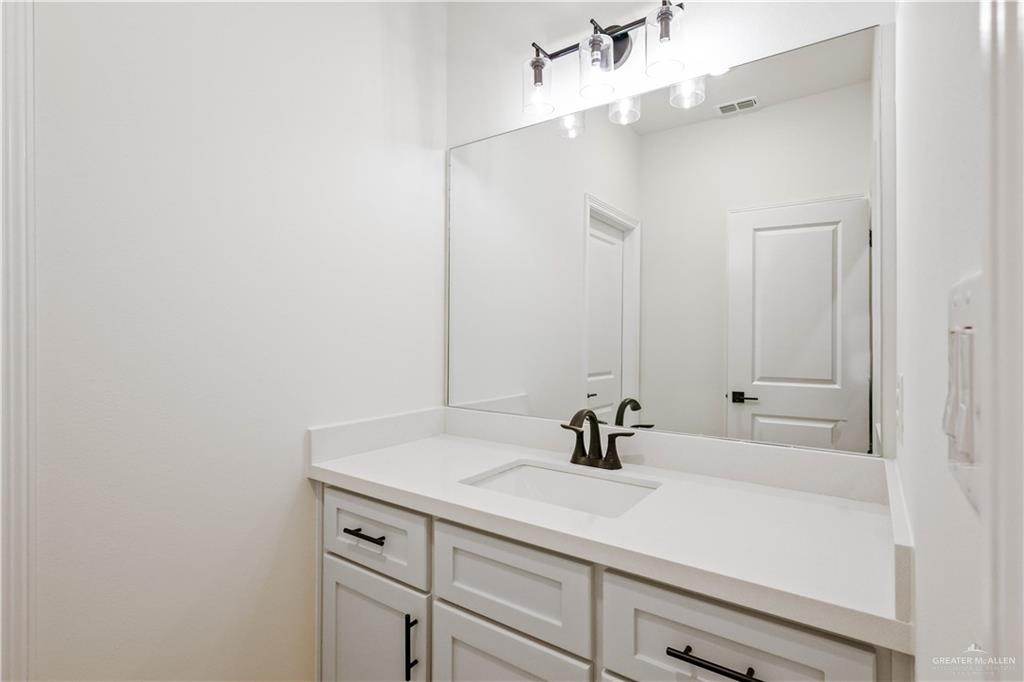 7305 North 55th Lane Mission, TX 78573 - Photo 16 of 26 a bathroom with a sink and a mirror