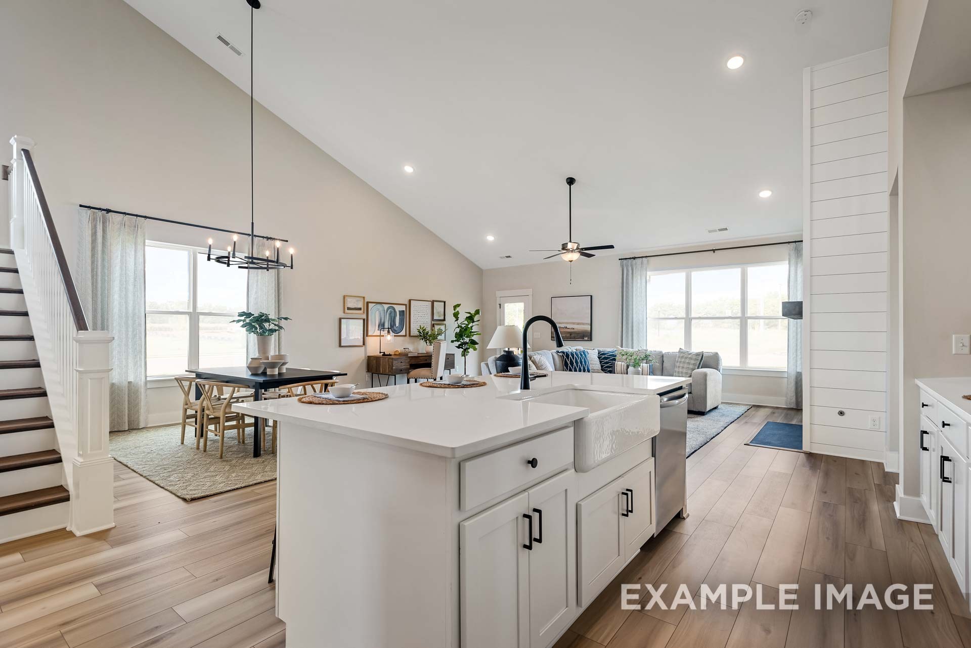 2882 Barnwood Road Gallatin, TN 37066 - Photo 14 of 99 a large kitchen with kitchen island a stove a sink a refrigerator and a dining table with wooden floor