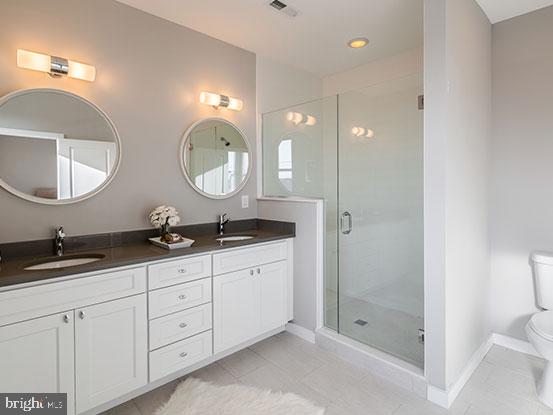 4427 Mitchell Street Philadelphia, PA 19128 - Photo 20 of 24 a bathroom with double sink and a mirror