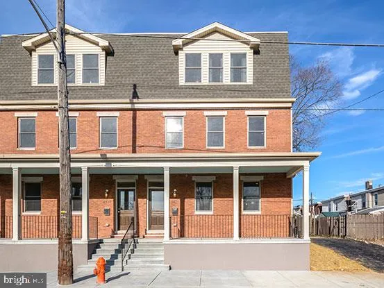 a front view of a residential apartment building with a yard