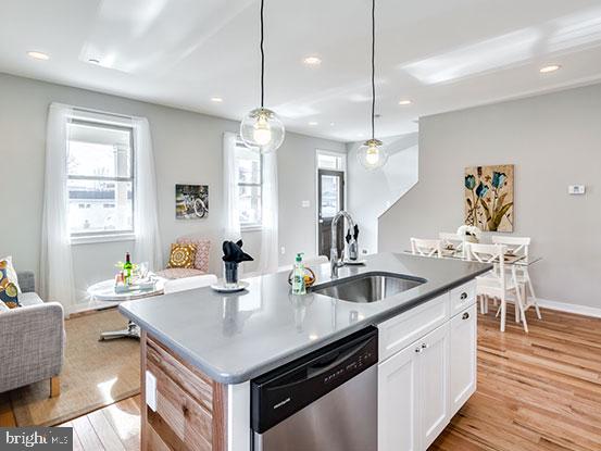 4427 Mitchell Street Philadelphia, PA 19128 - Photo 6 of 24 a kitchen with granite countertop a sink a counter space appliances and wooden floor