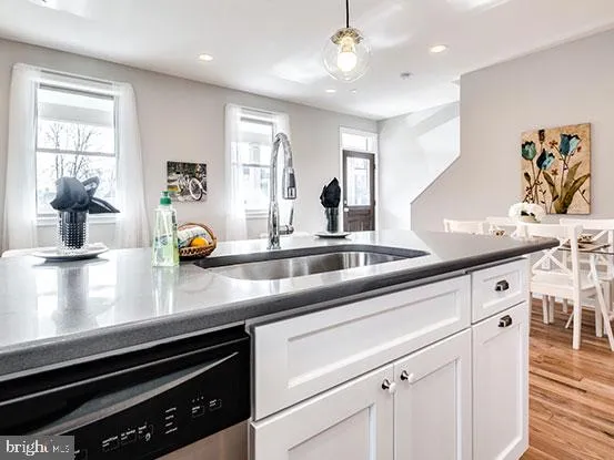 a kitchen with stainless steel appliances a sink a stove and cabinets