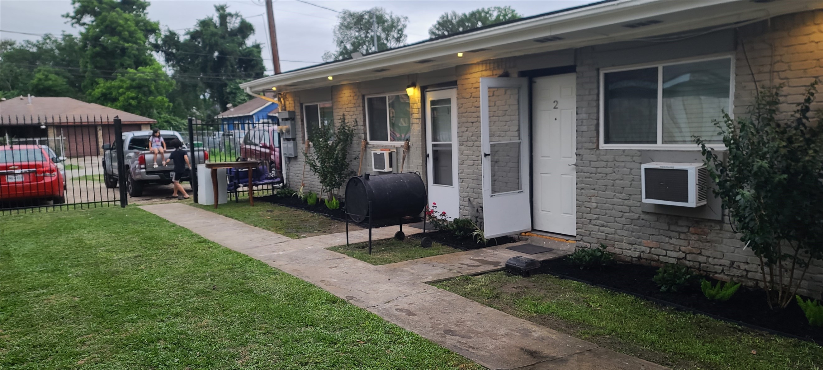 a view of a chair and table in backyard of the house