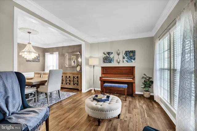 a kitchen with refrigerator a sink and chairs