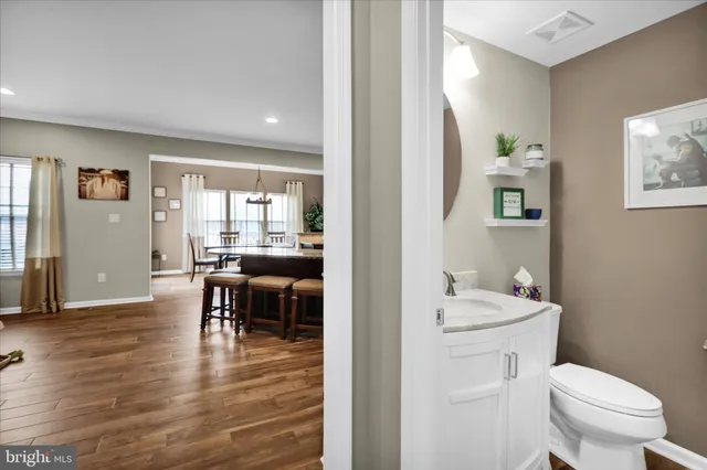 a view of a livingroom with furniture a flat screen tv and fireplace