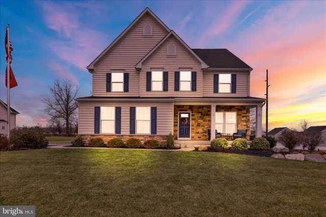 a view of a house with a yard and sitting area